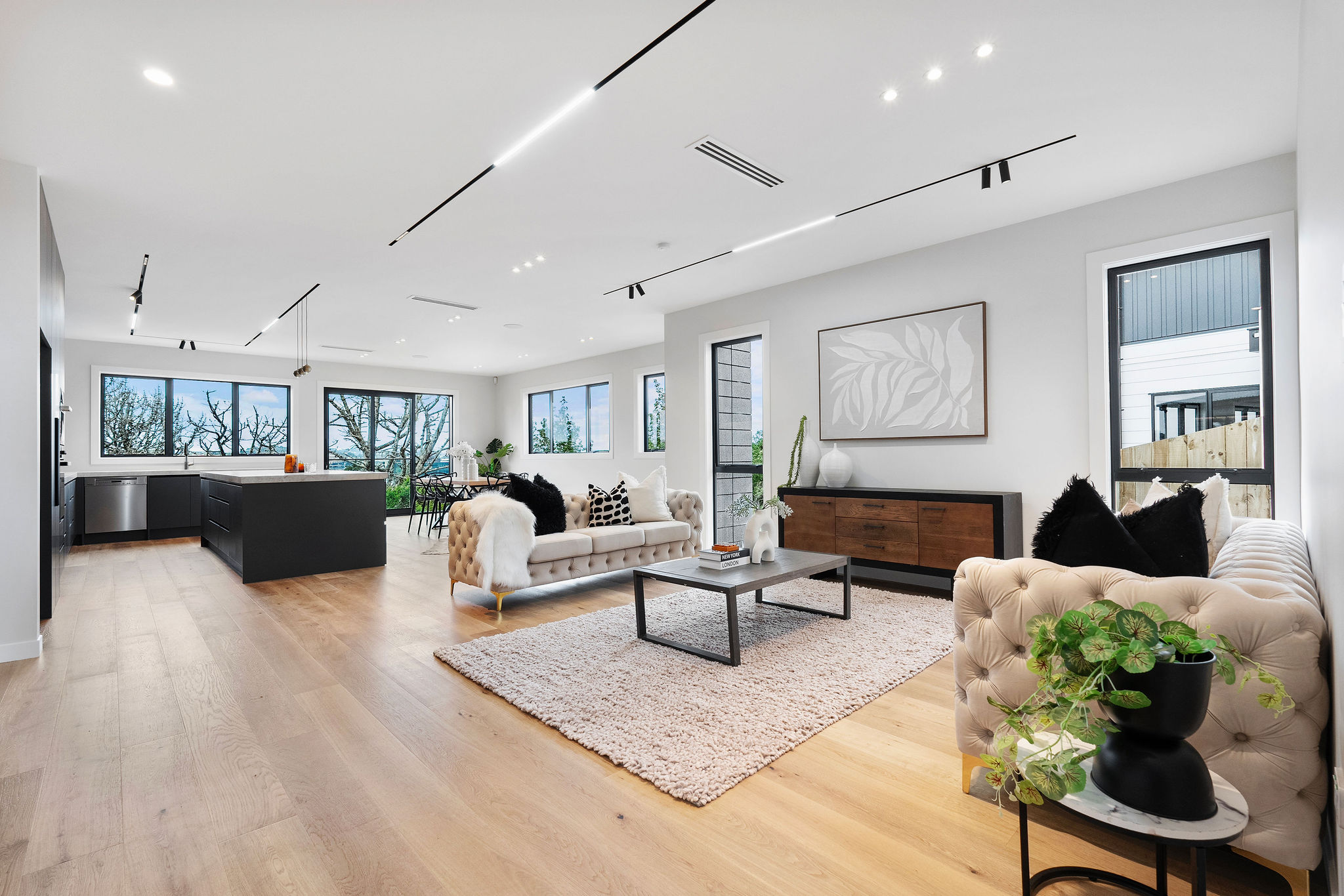 Generous living room with pale timber flooring