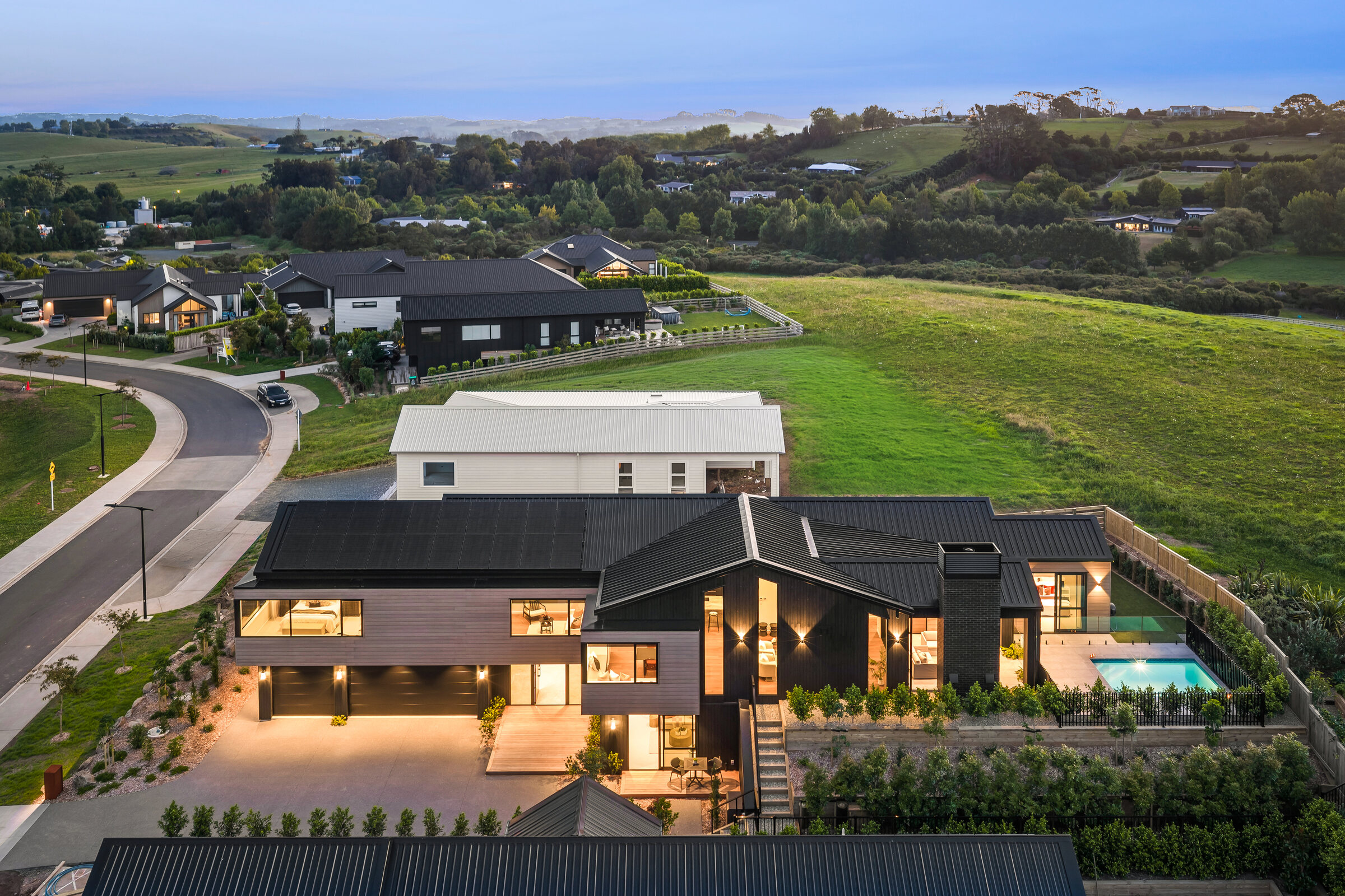 Aerial view of 25 Penney Rise, a completed Matakana residence with landscaped grounds and pool