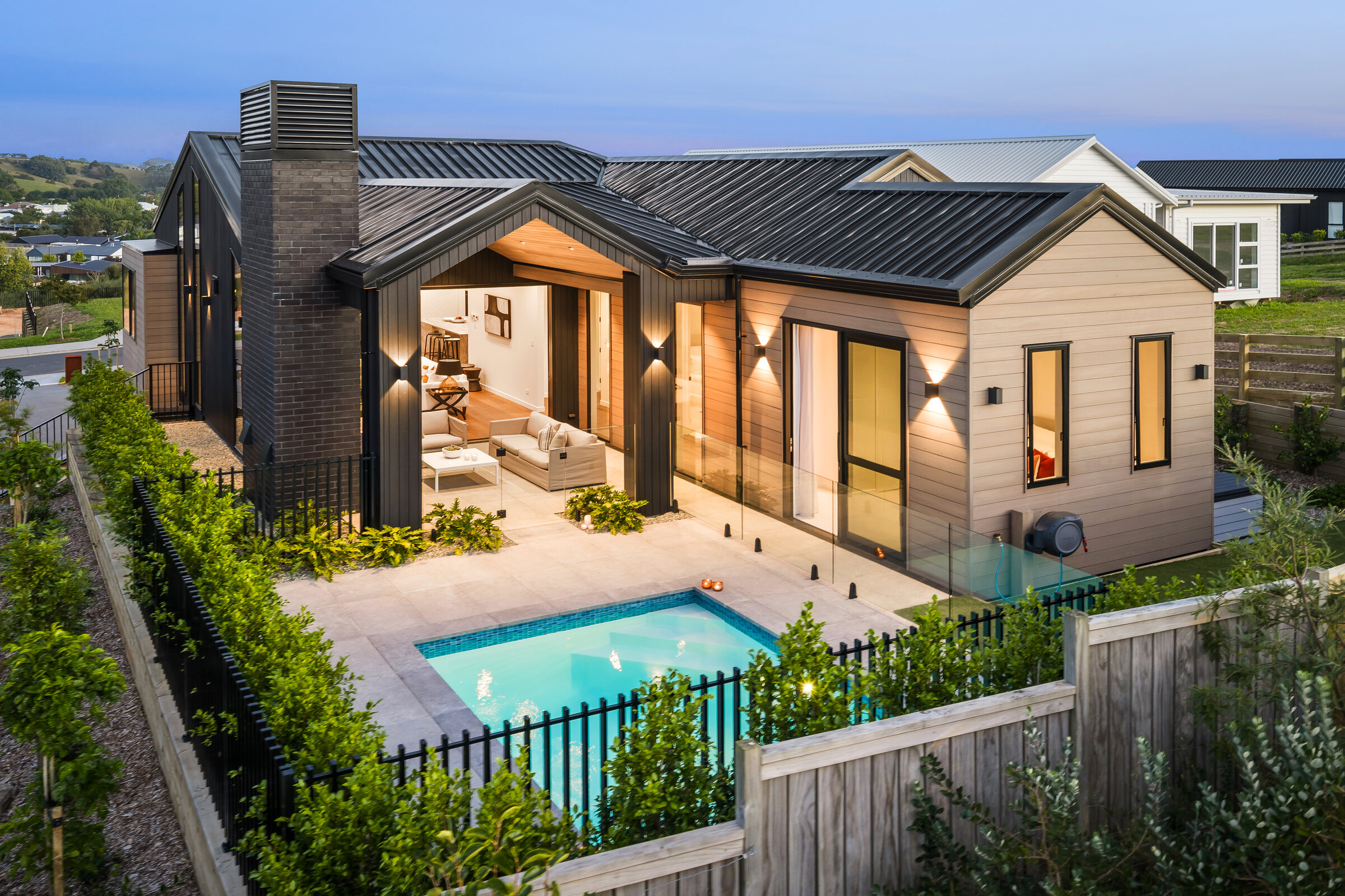 Aerial overview of the completed home, pool and Matakana landscape