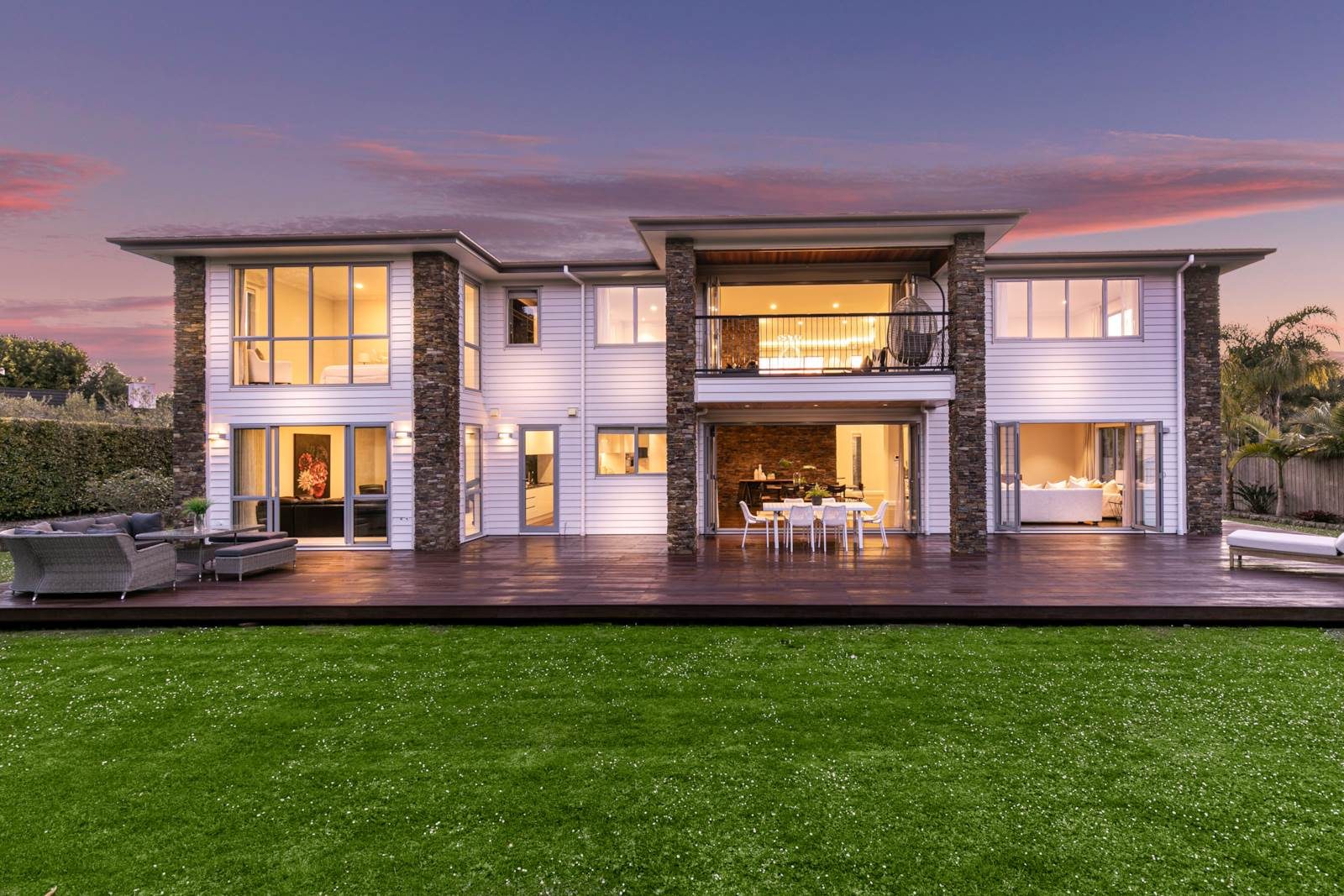 Rear elevation and terrace of the Greenhithe home at dusk