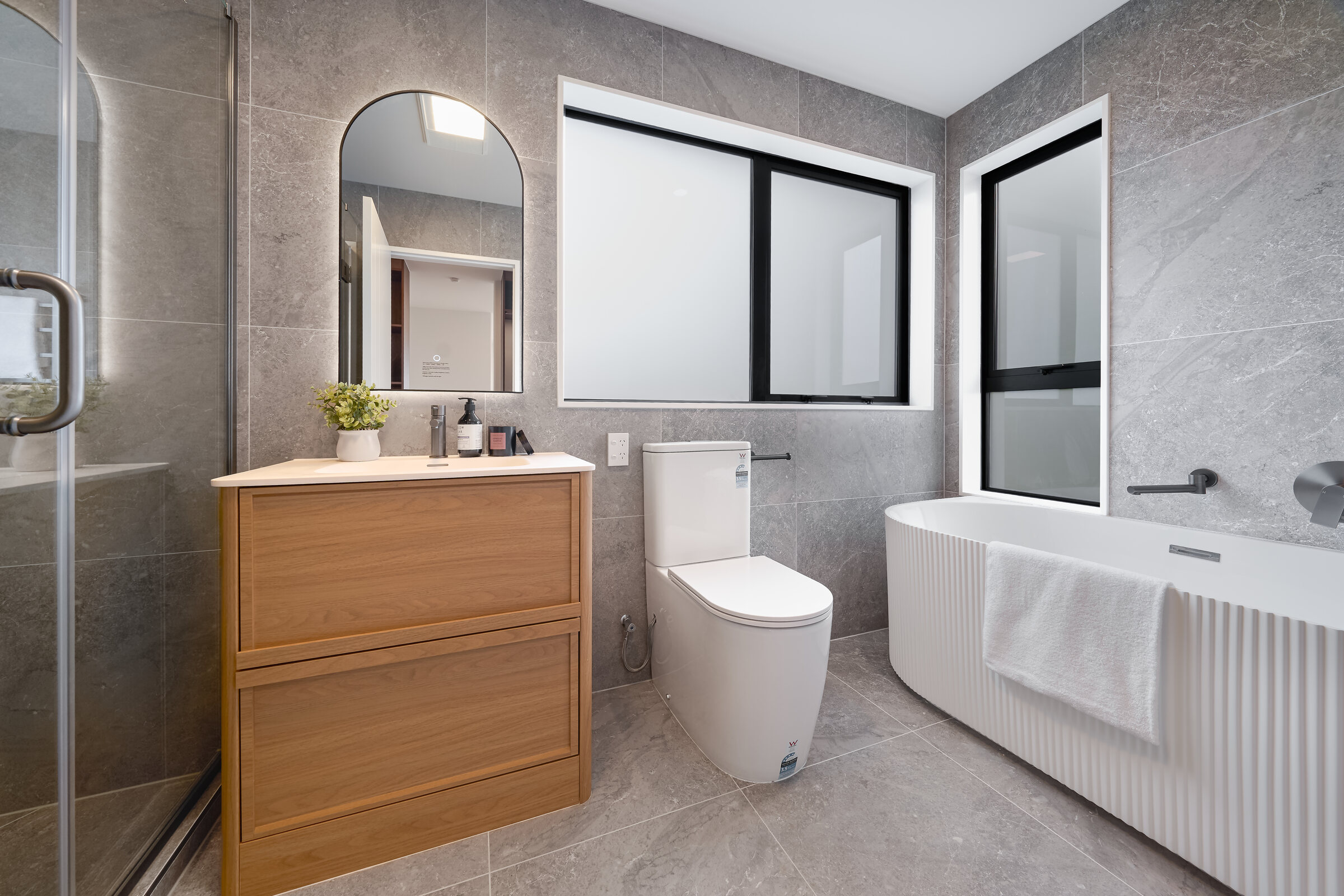 Tiled bathroom with timber vanity at 387 Albany Highway