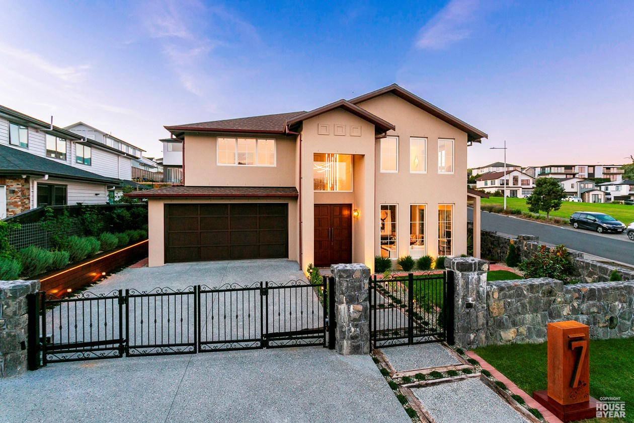 Completed two-storey home at 7 Luff Place, Long Bay, viewed from the street at dusk