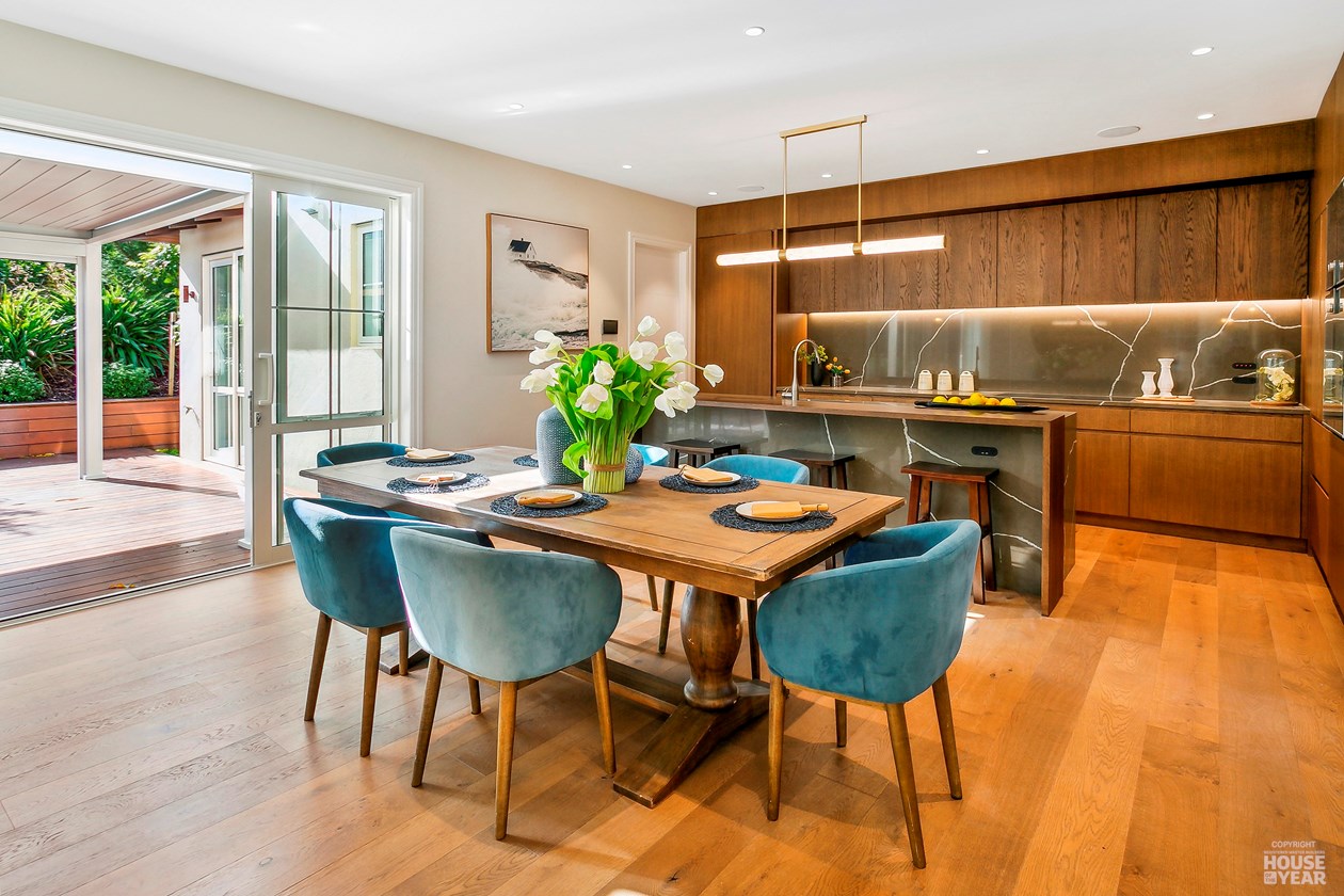 Dining room and kitchen opening to a covered outdoor area