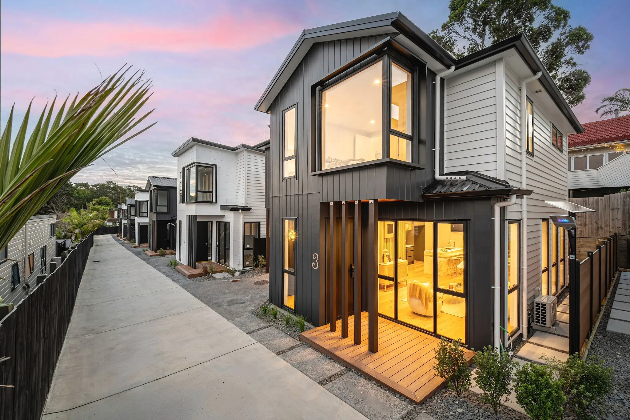Twilight view of the completed nine-home development at 8 Park Rise in Campbells Bay