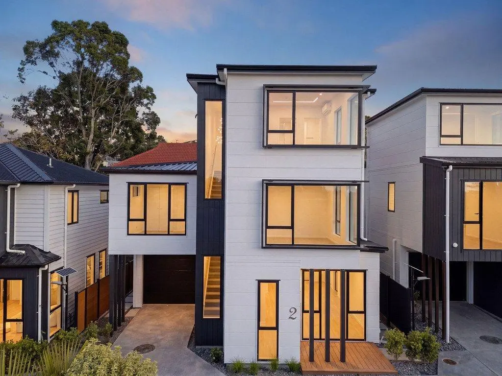 Front view of a three-level home responding to the sloping site