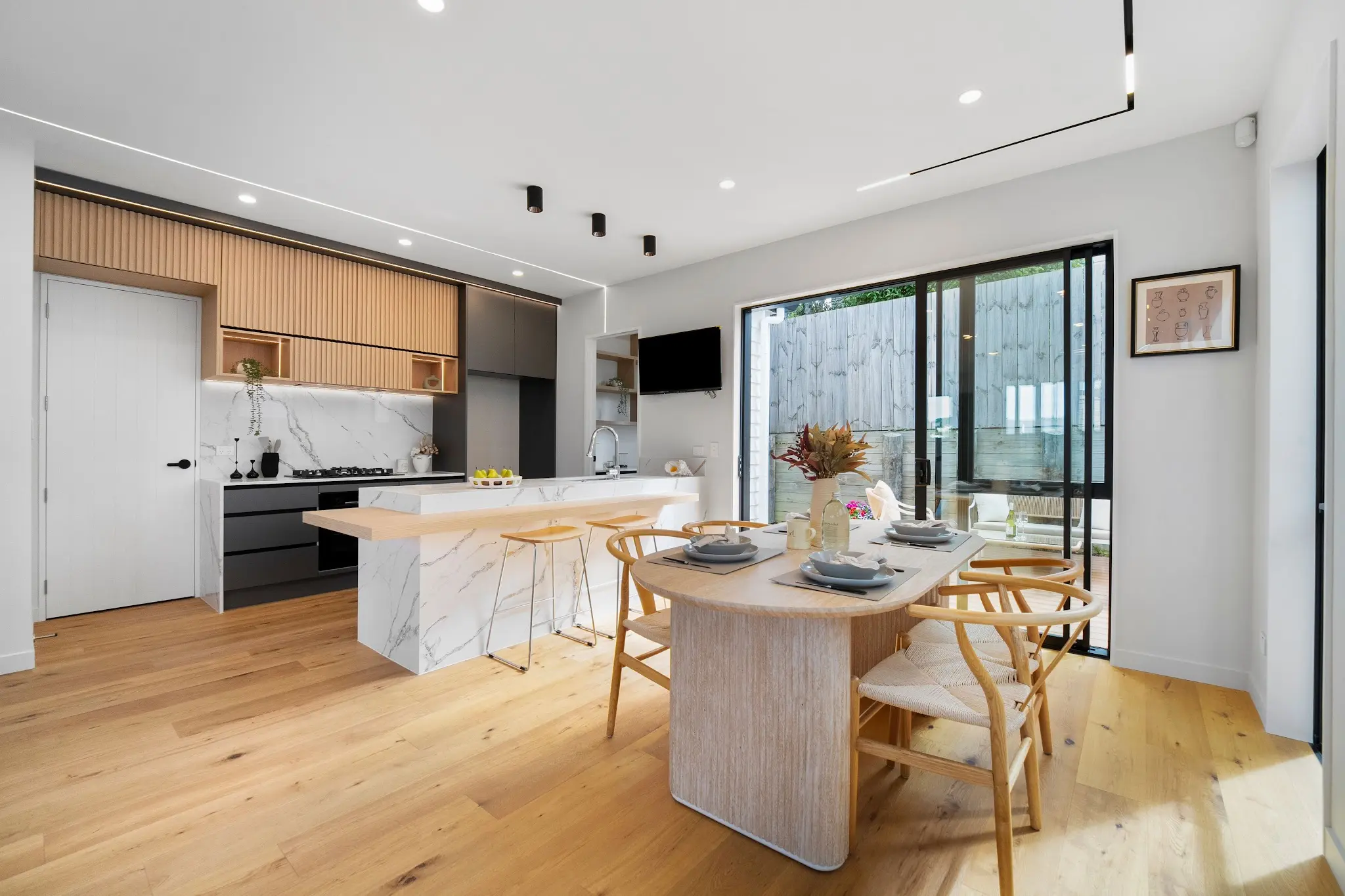 Open-plan kitchen and dining space with timber finishes