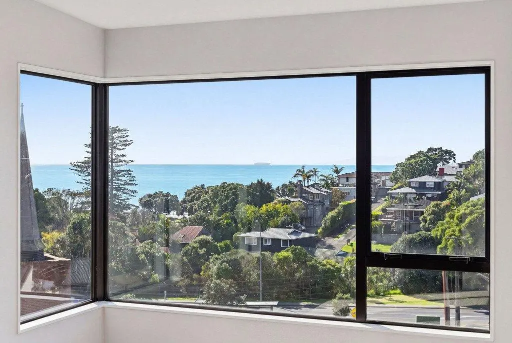 Coastal outlook from an upper-level corner window