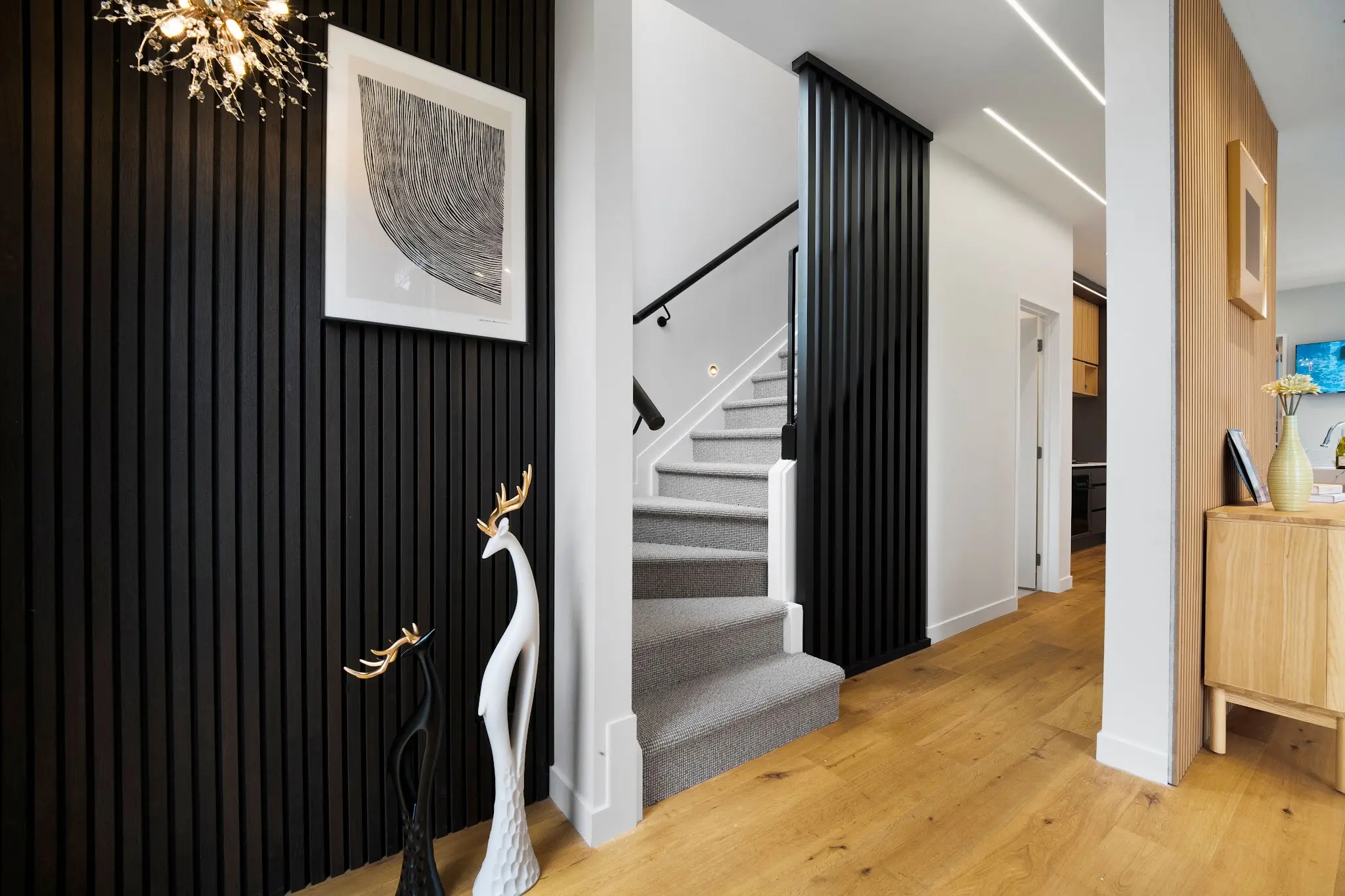 Interior stair with black slatted screens and warm timber detailing