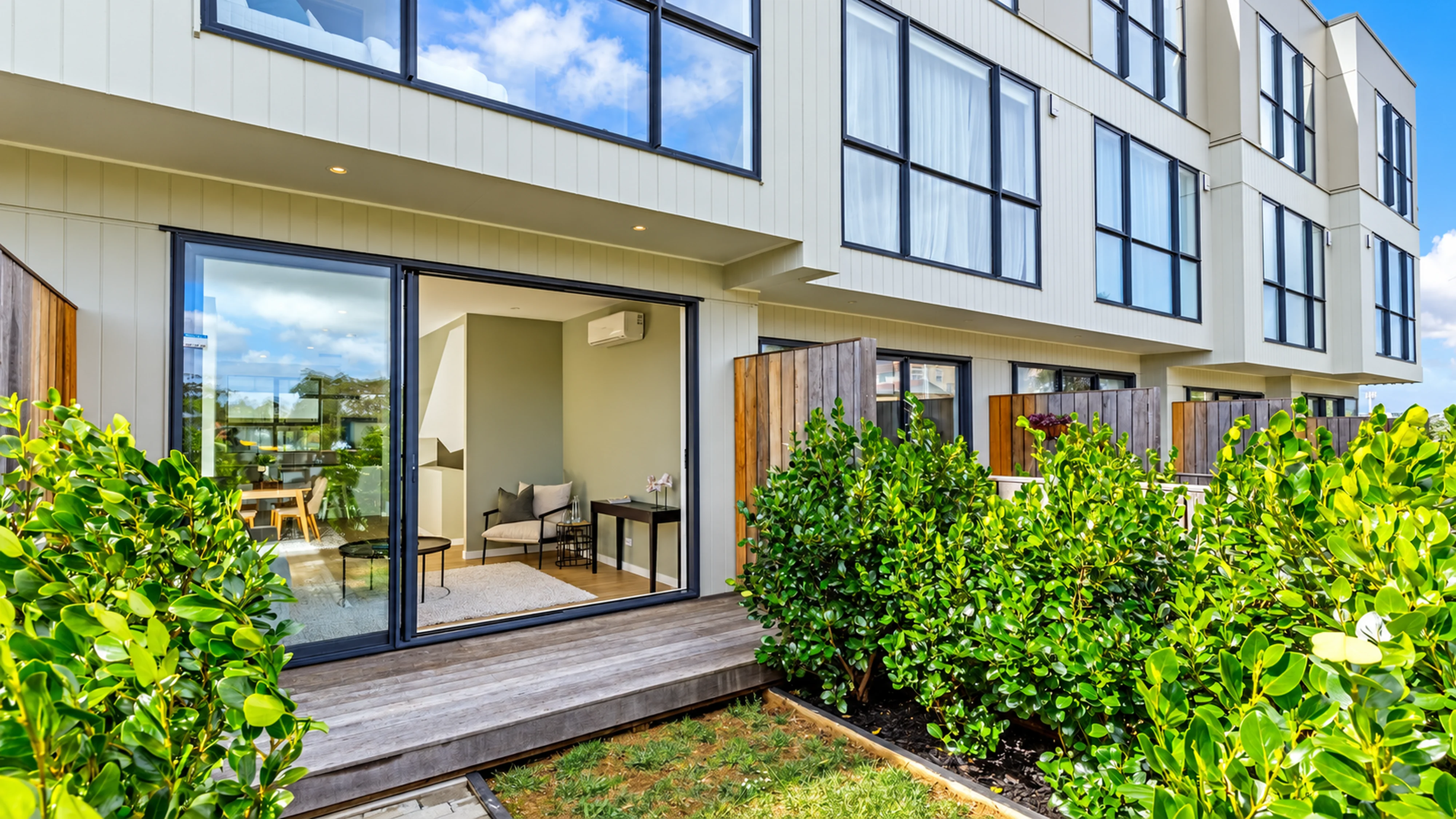 Private planted courtyard and deck beside one of the homes
