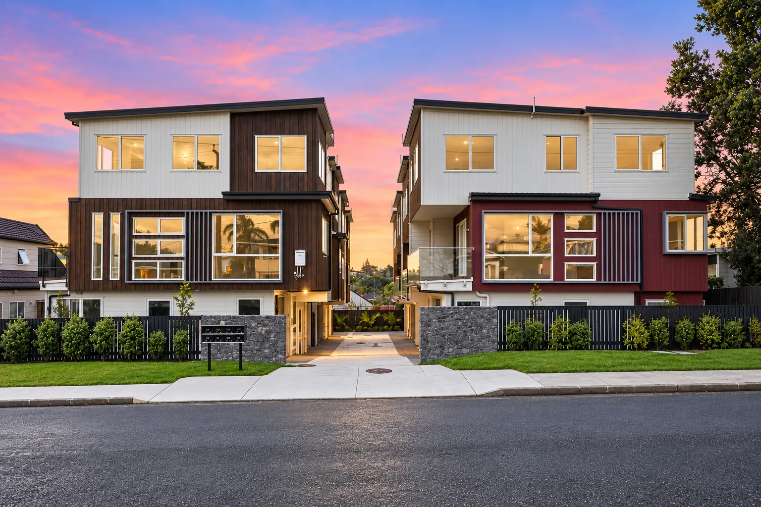 Street elevation of the Corrella Road homes at dusk with planted frontages