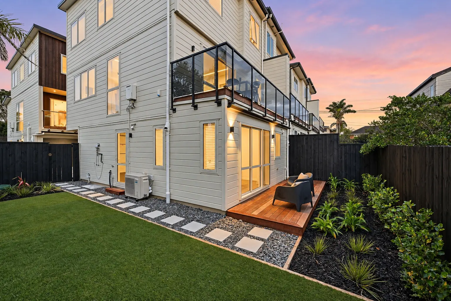Rear garden and outdoor living area beside one of the Belmont homes