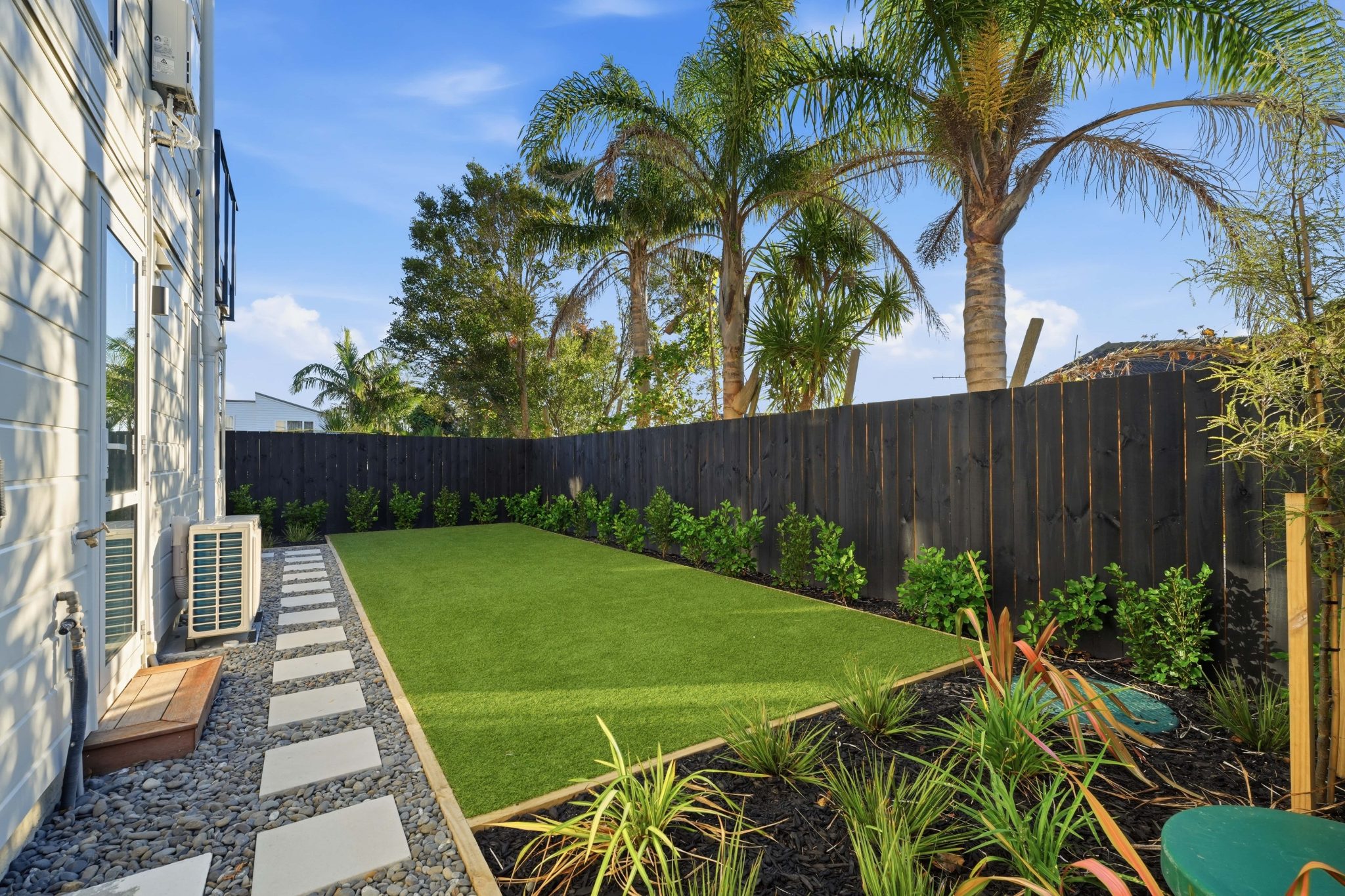 Private lawn and planted garden beside one of the homes