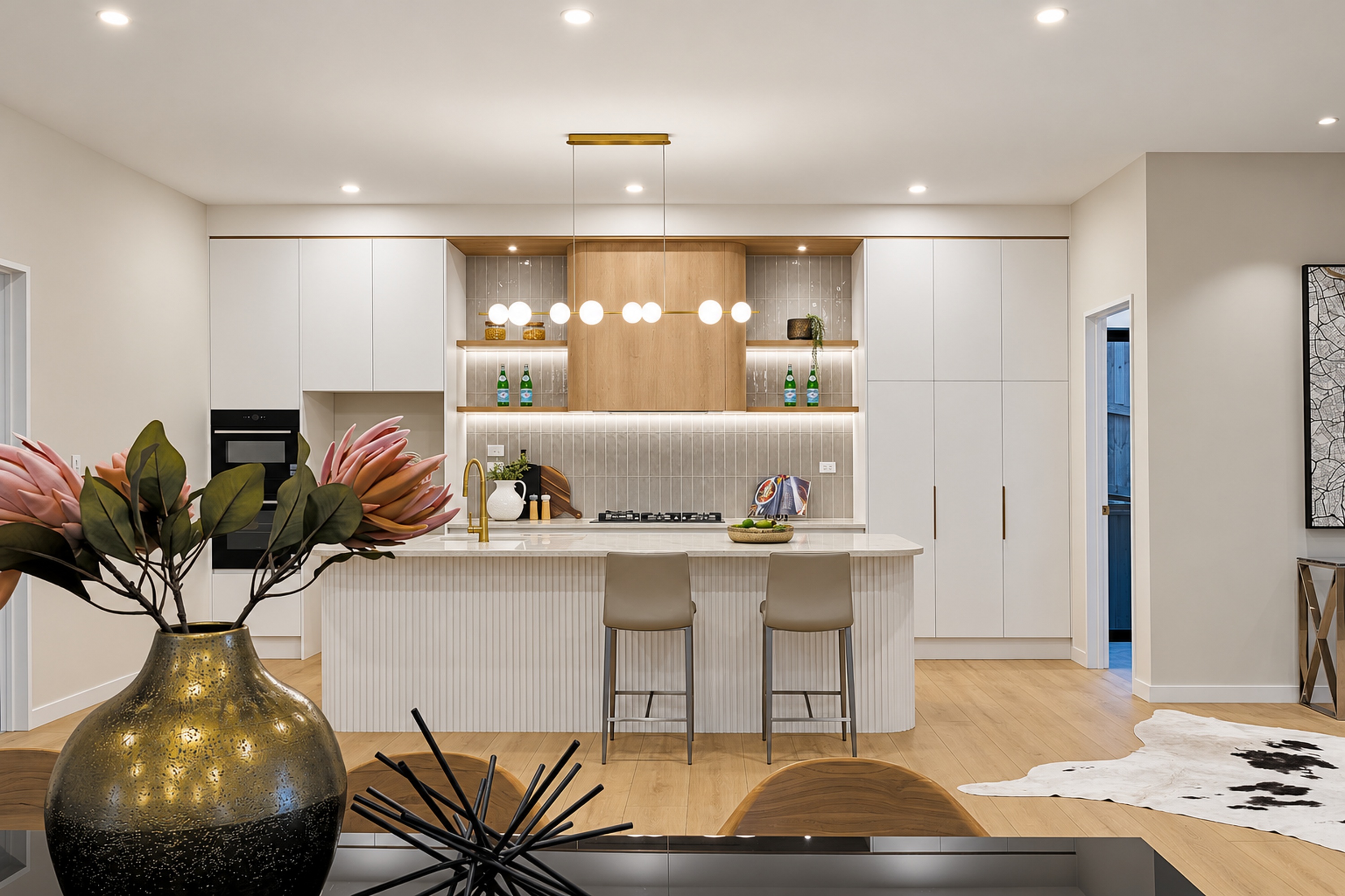 Light-filled kitchen with white cabinetry, timber accents and an island bench