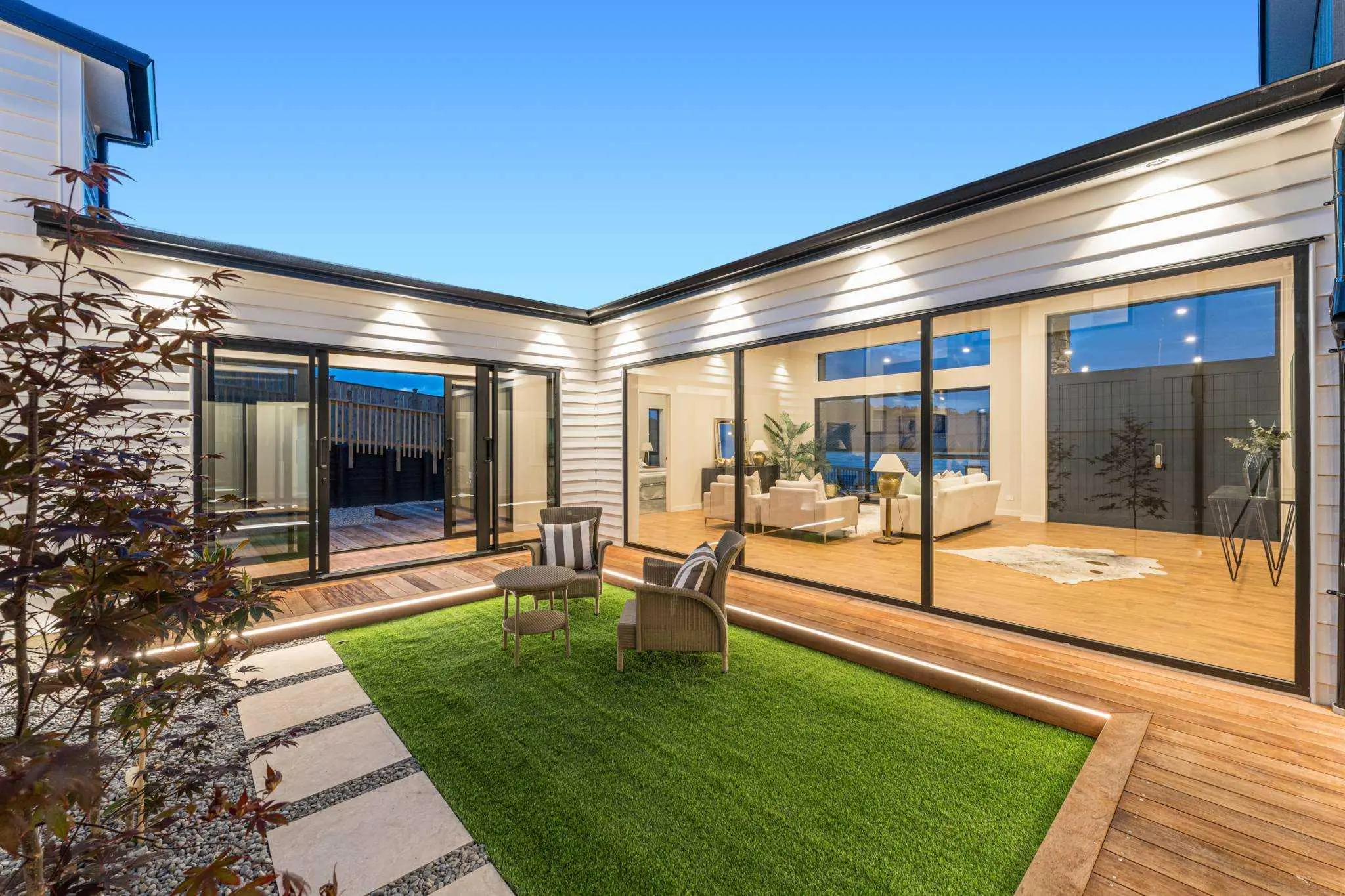 Sheltered central courtyard surrounded by glazed living spaces