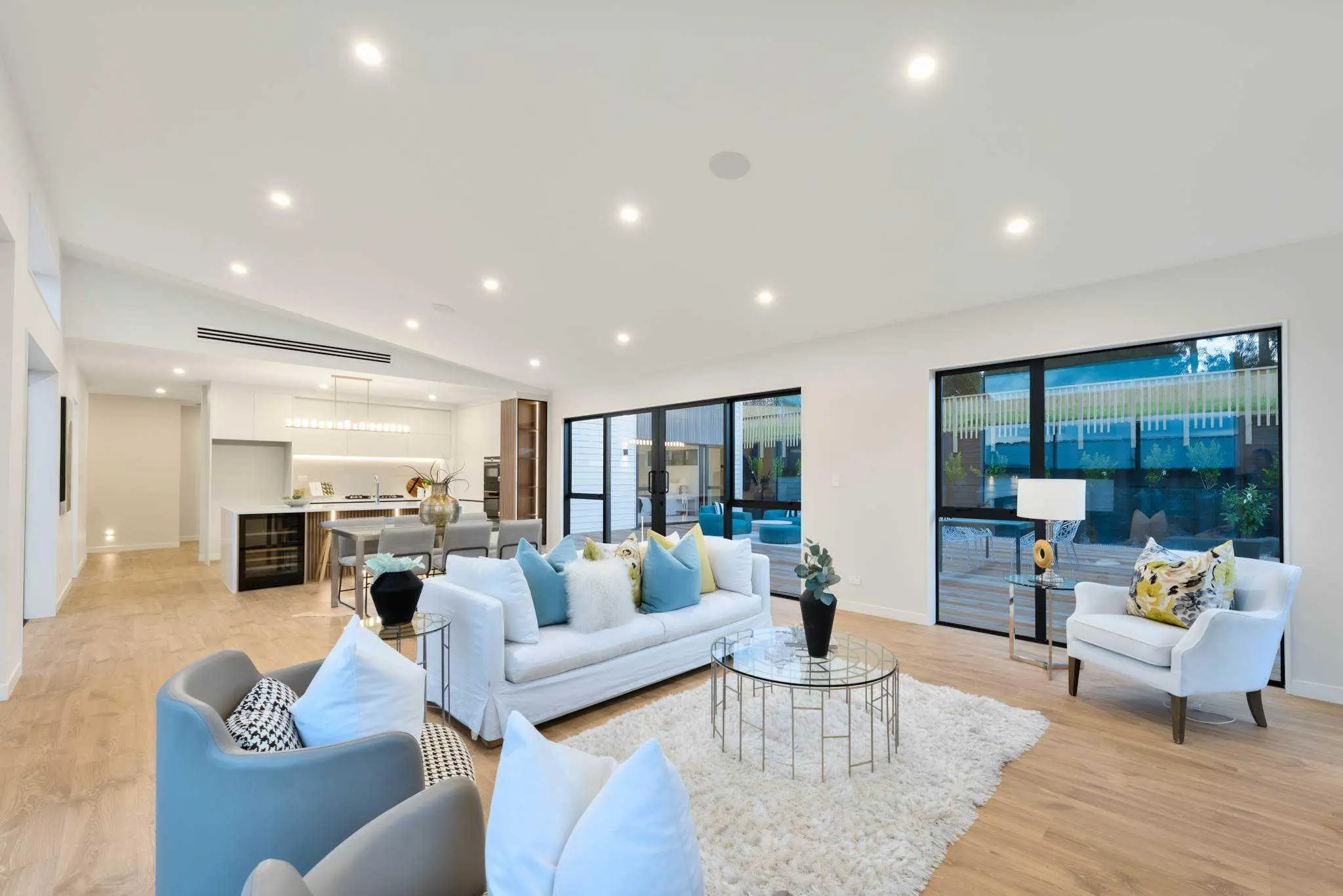 Open-plan living room looking toward the kitchen and courtyard