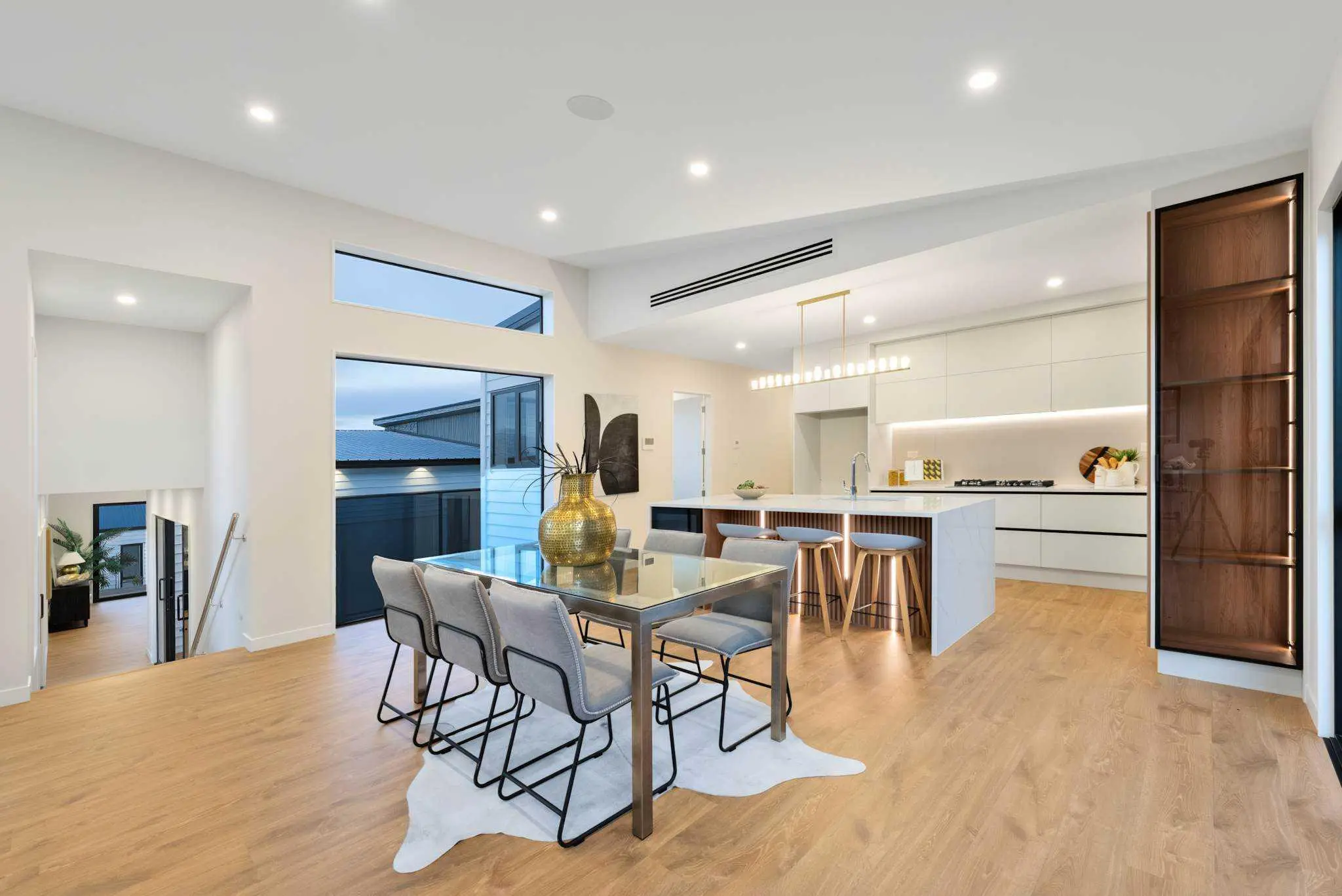 Kitchen and dining room with timber floor and large windows