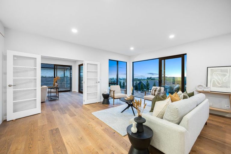 Light-filled living room with large windows and timber flooring