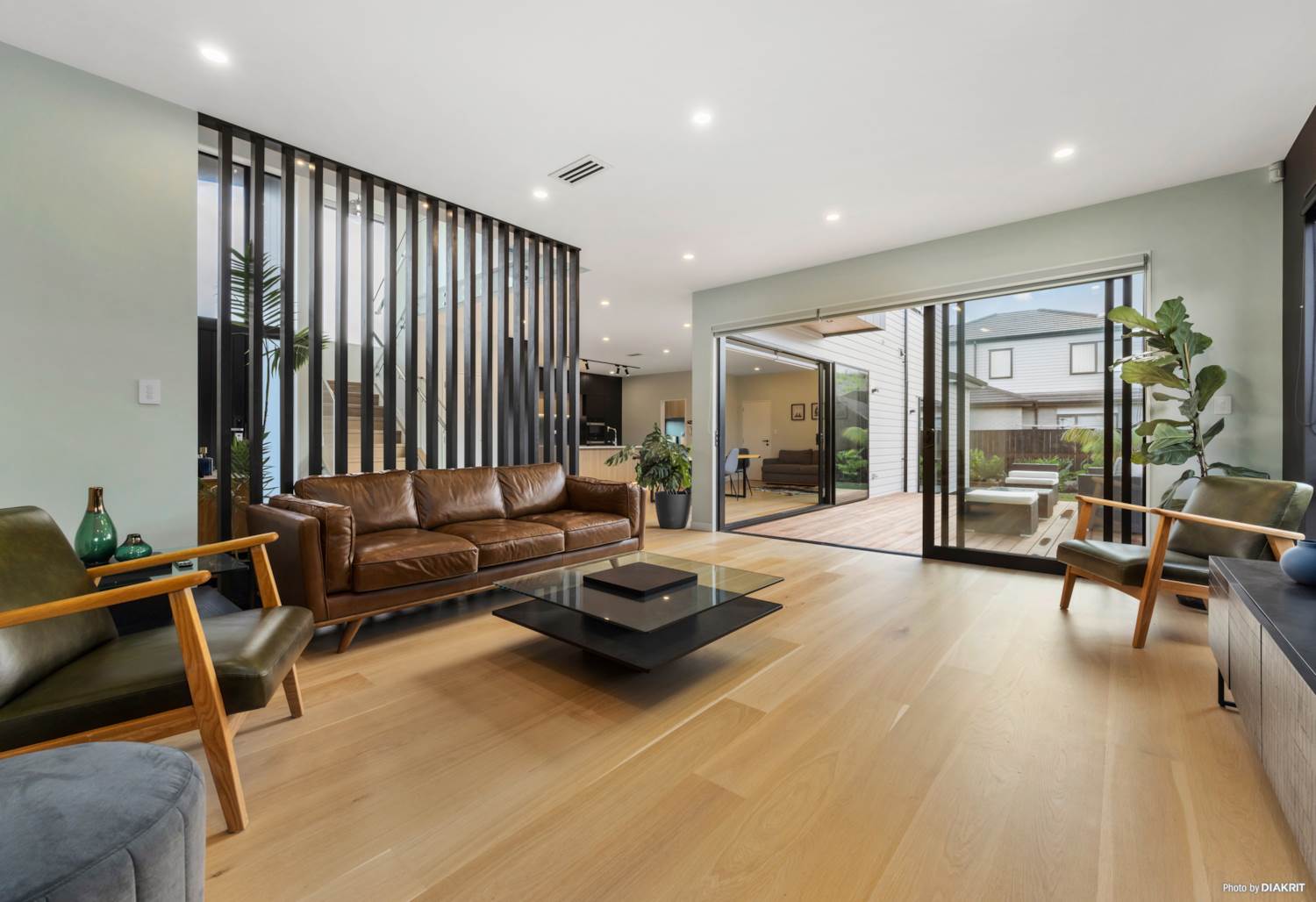 Living room with timber screen opening onto a sheltered courtyard