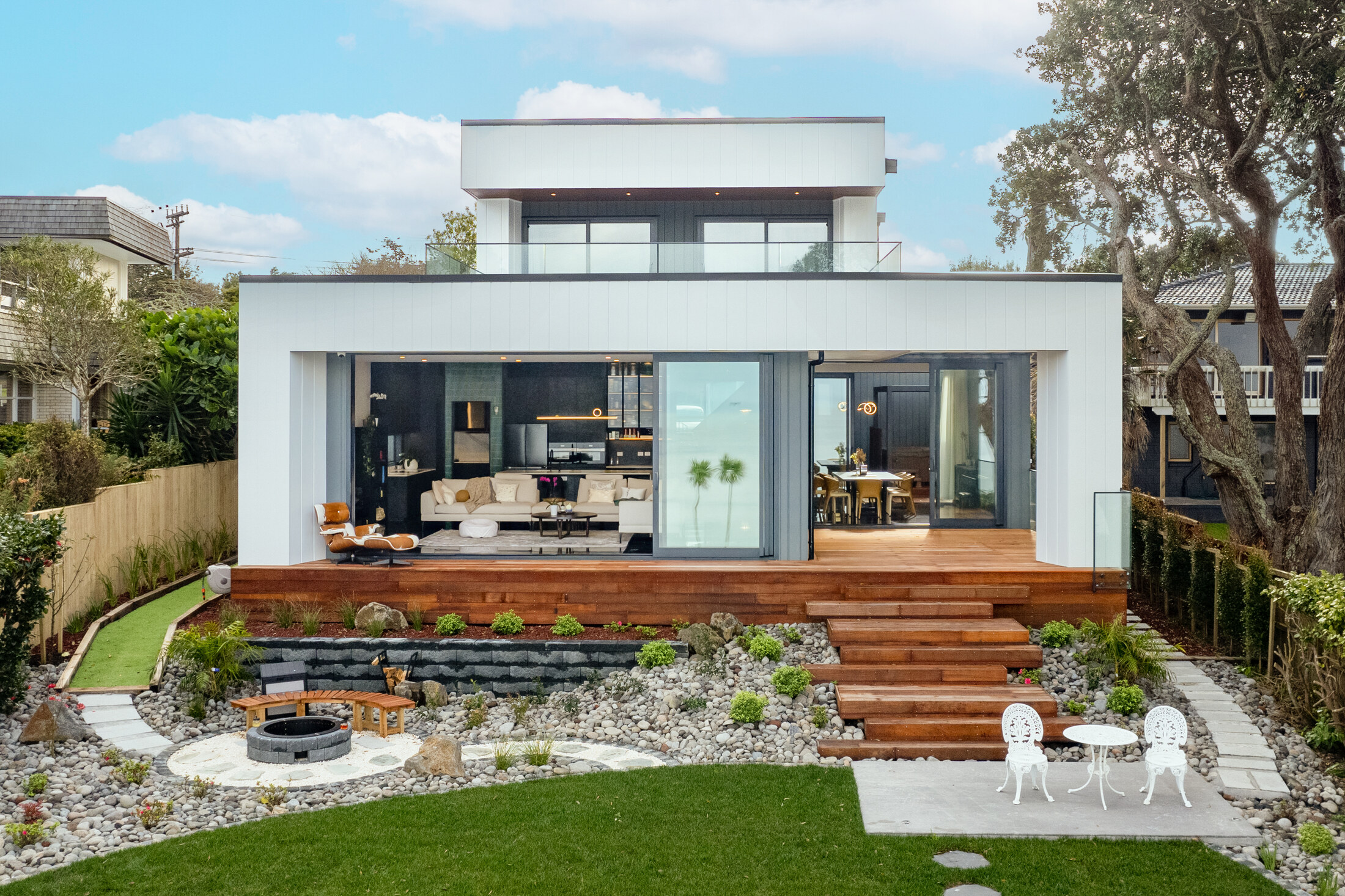 Contemporary coastal residence at 26 Rock Isle Road in Torbay with a raised timber terrace and landscaped garden