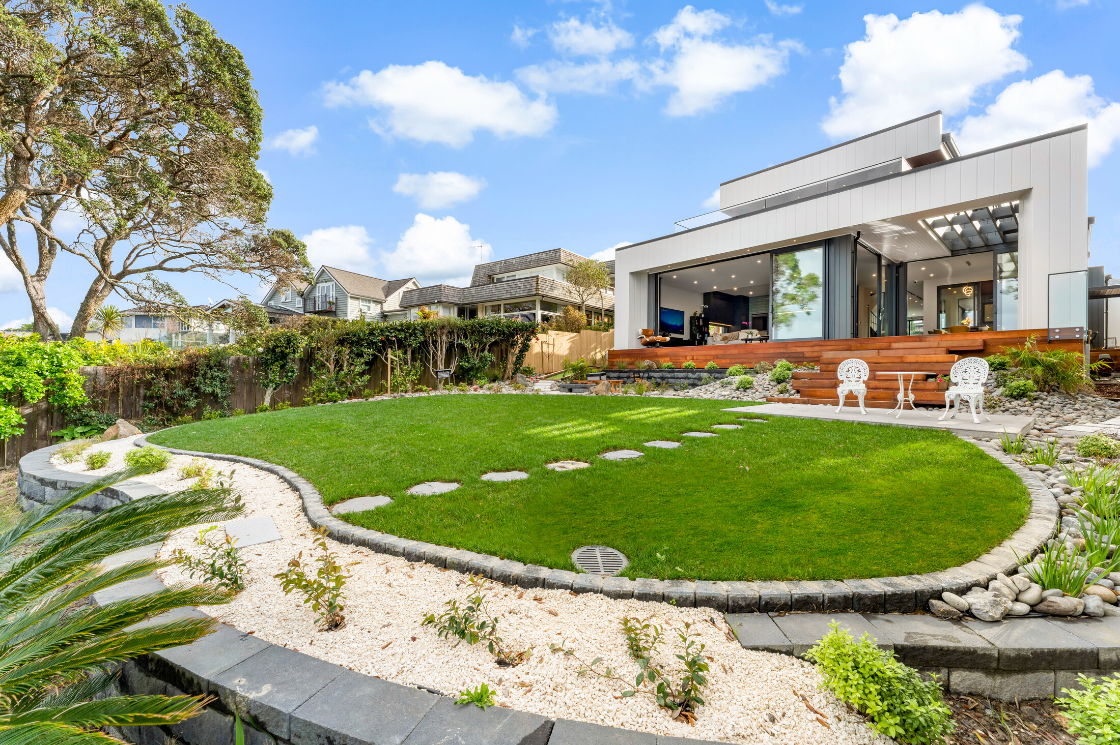 Landscaped lawn and modern facade at 26 Rock Isle Road