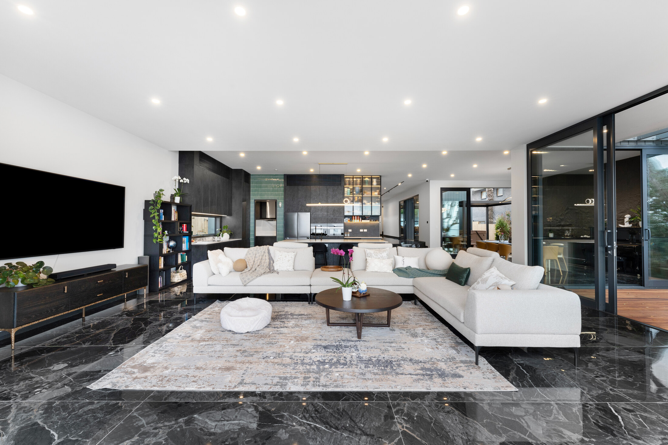 Main living room with dark stone flooring and harbour outlook